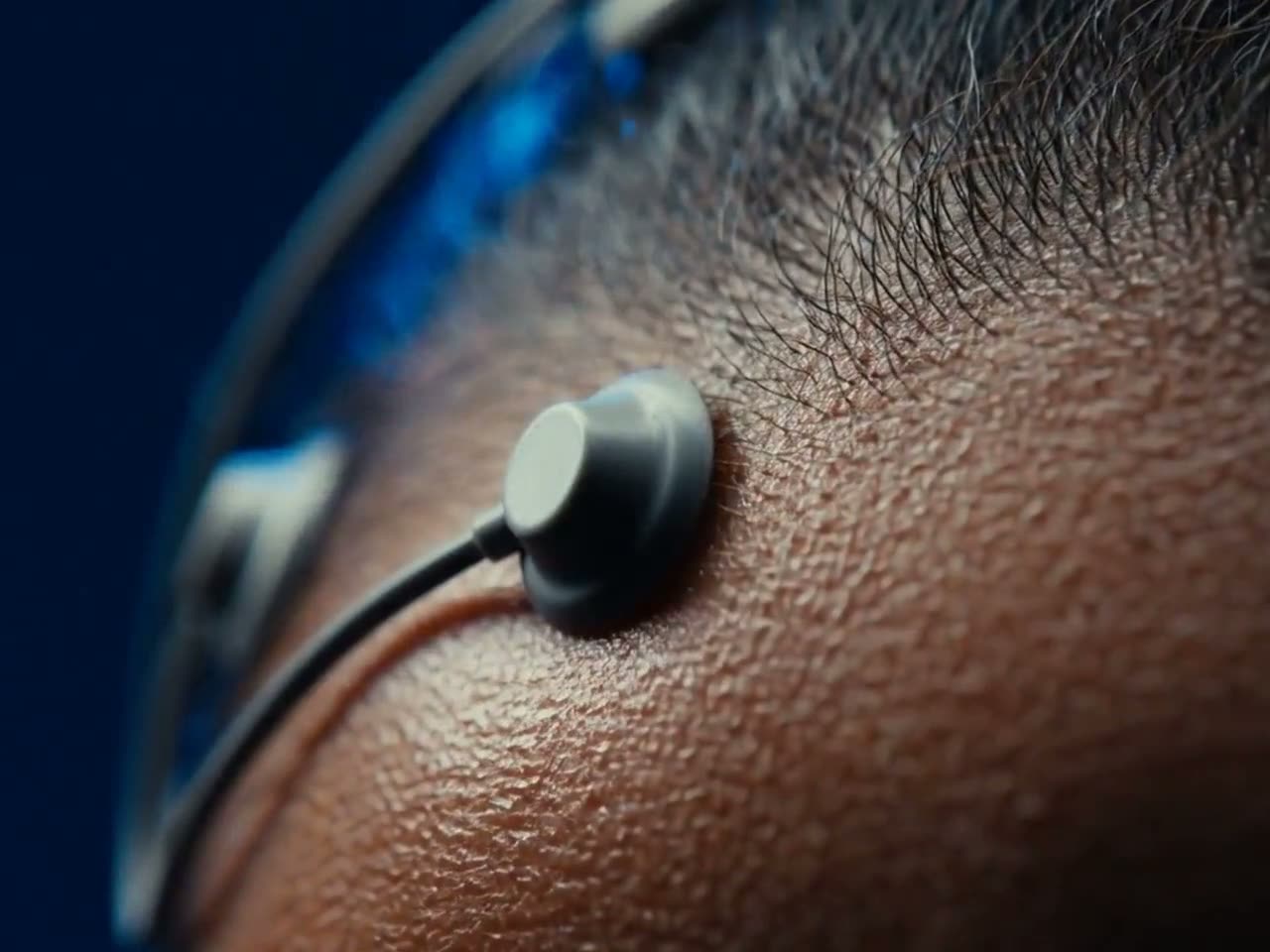 Macro view of an Emotiv EEG sensor resting against the scalp